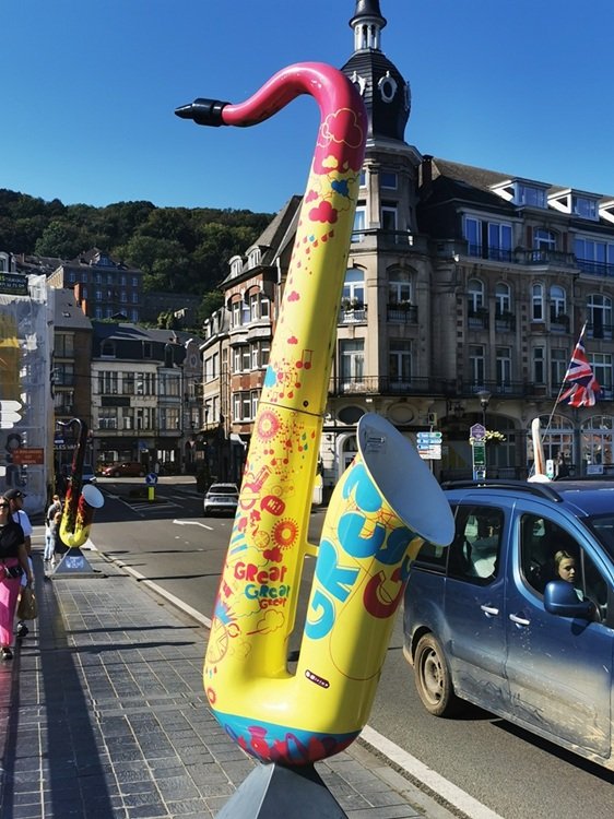Brightly colored saxophones on the bridge at Dinant